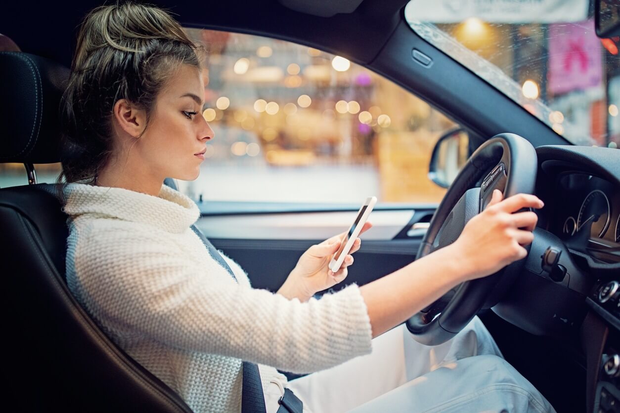 Young girl is texting in the traffic jam