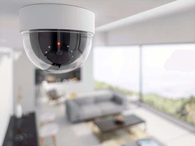Security camera mounted on ceiling in living room