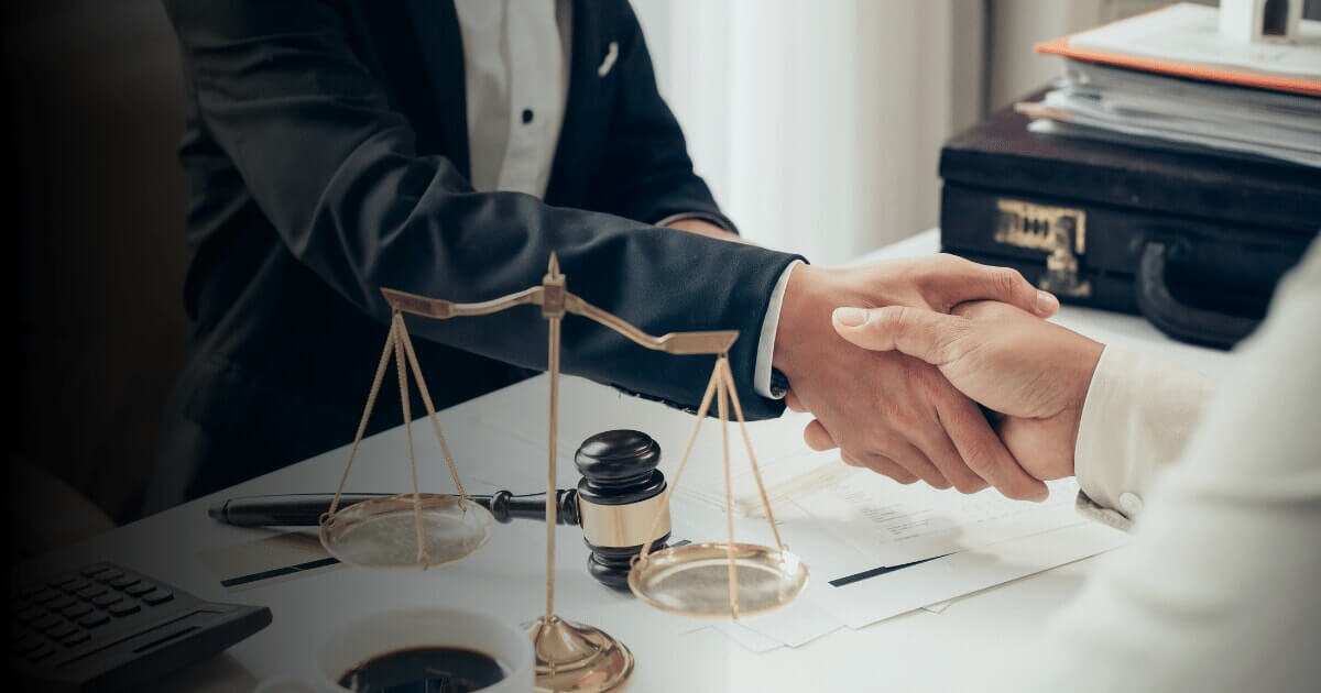 A personal injury lawyer shaking hands with an accident injury victim